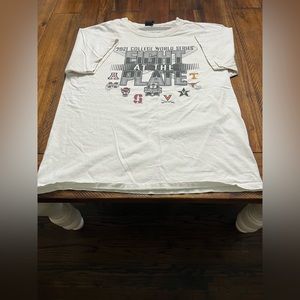 College world series shirt. A white shirt with all teams that were in that year.